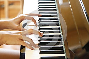 Closeup of fingers playing piano