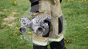 Closeup of a firefighter standing holding fire and branching