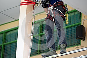 Closeup of firefighters lower body training for fire drill by demonstrate how to escape from burning building with safety rope