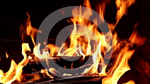 Closeup of fireplace full of wood and fire