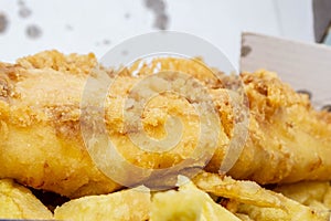 Closeup of fish chips and curry sauce in England