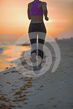 Closeup on fitness young woman running on beach in the evening