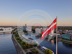 Closeup of the flag of Latvia in the AB Dam park under the sunlight in Riga