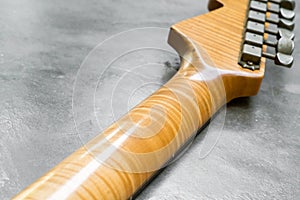 Closeup of flame maple headstock guitar