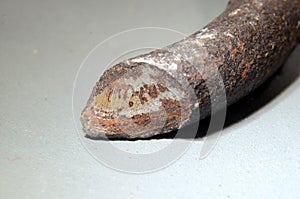 Closeup with focus on the surface of a fracture in a car spring. This spring broke because of metal fatigue. The fracture has a