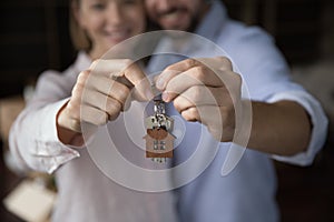 Closeup focus, wife and husband hands holding bunch of keys