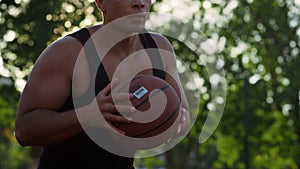 Closeup focused streetball player making attempt to score goal outdoors.