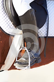 Closeup, foot and stirrup for horse riding, sport or safety with animal for race, contest or competition. Rider