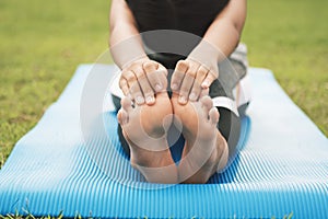 closeup foots of a young woman practicing yoga