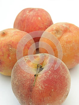 Closeup Four peaches on white background