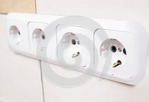 Closeup of Four Power Outlets Together in Line photo