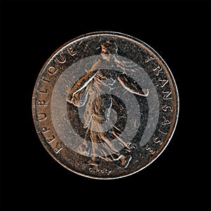 Closeup of a 5 francs coin from 1991 on a black background, the former French national currency