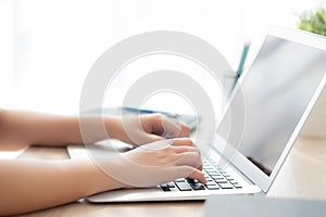 Closeup freelance asian woman working and typing on laptop computer at desk office with professional