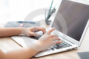 Closeup freelance asian woman working and typing on laptop computer at desk office with professional