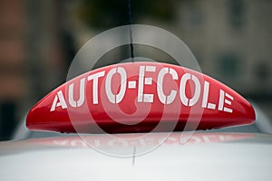 French driving school panel on the car roof , text in french