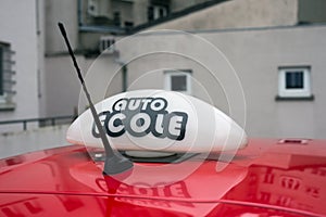 French driving school panel on the car roof , text in french