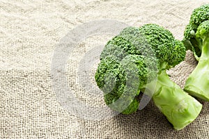 Closeup fresh broccoli on sackcloth background, raw food for cooking