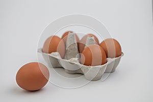 Closeup of fresh brown eggs over white background