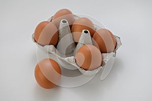 Closeup of fresh brown eggs over white background