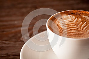 Closeup of a fresh cup of coffee with milk froth