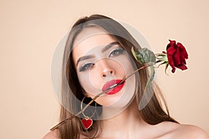 Closeup fresh face girl. Brunette woman with red rose. Beautiful girl with reses flowers. Closeup face of young