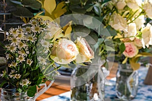 Closeup of fresh flowers arranged in mason jars