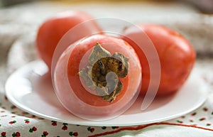 Closeup of fresh fruits persimmon in autumn colors, orange and d