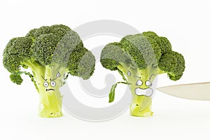 Fresh broccoli with scared cartoon style faces on white background