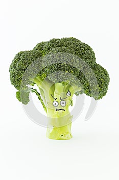 Fresh broccoli with scared cartoon style faces on white background