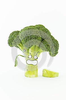 Fresh broccoli with scared cartoon style faces on white background