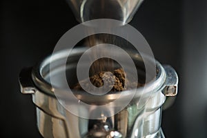 Closeup of fresh grinding coffee rosted in the coffee house