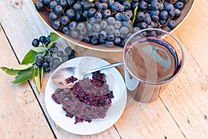 Closeup of fresh juice and jam of ripe black chokeberry Aronia melanocarpa