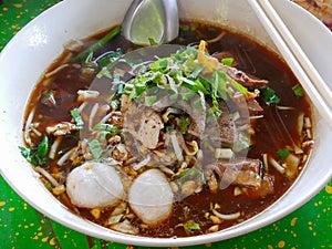 Closeup of fresh noodles soup with pork and its tasty thick broth Guay Tiao Nam Tok Moo photo