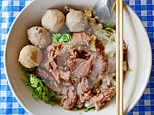 Closeup of fresh noodles soup with stewed beef Guay Tiao Nuea - delicious and healthy street food in Thailand photo