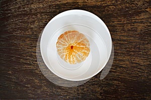 Closeup of fresh peeled orange on wooden background