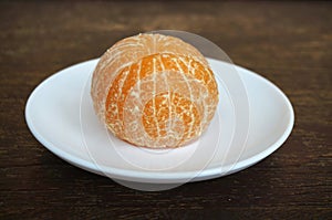 Closeup of fresh peeled orange on wooden background