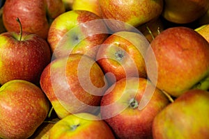 Closeup of fresh red-green apples on supermarket counter