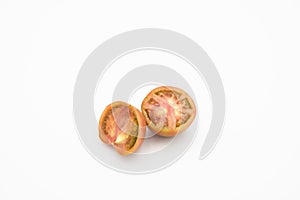 Closeup of a fresh ripe tomato cut in half isolated on a white background