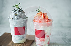 Closeup fresh strawberry milkshake, smoothie and fresh strawberries topping on stone table background. Healthy food and summer
