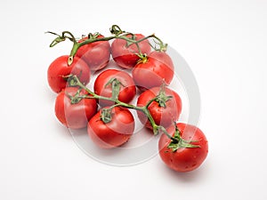 Closeup of fresh tomatoes on the vine isolated on white