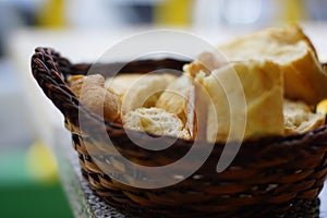 Closeup of fresh white bread for breakfast in brown wicker basket. Macro photo, bread texture