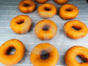 Closeup of freshly made dark brown doughnuts