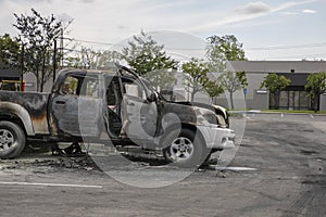 Closeup of the front of a burned truck in a parking lot