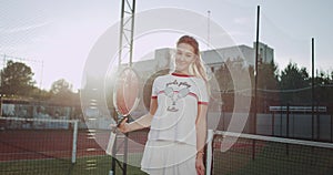 Closeup in front of the camera sportiv woman on the tennis court playing with a tennis racquet. 4k