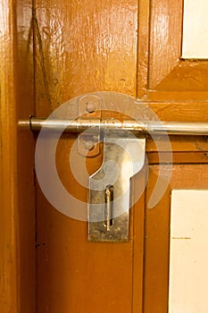 Closeup front view exterior rusty rough old brown wooden door handle of iron metal frame with in grungy style and good texture of