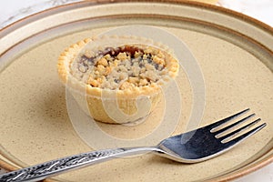 Closeup fruit crumble tart with a fork