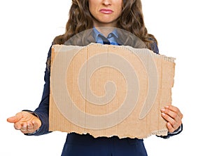 Closeup on frustrated business woman showing blank cardboard
