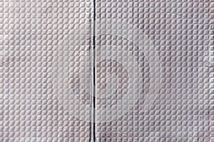 Closeup full-frame background and texture of aluminum coated butil rubber sheet with square pattern. photo