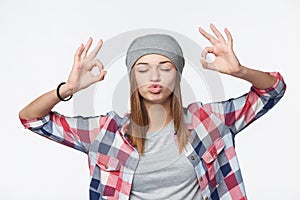 Funny teen girl calming herself gesturing OK signs photo