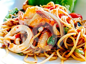 Closeup fusion seafood stir fried spicy spaghetti